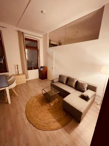 a living room with a couch and a rug at Retro Appartement im Herzen von Köln Deutz in Cologne