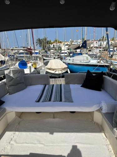 a bed in the back of a boat in a marina at Boat in Puerto de Mogán in Puerto de Mogán