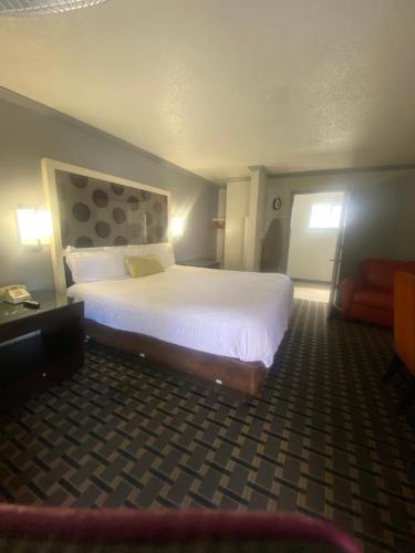 a hotel room with a large bed and a couch at Budget INN At The Heavenly Gondola in South Lake Tahoe