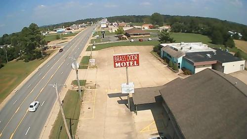 an overhead view of a bus stop motel sign on a road at Brass Door Motel in Gassville
