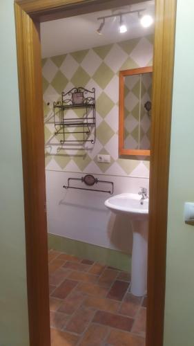 a bathroom with a sink and a toilet and a mirror at Chorrillo Alto in Torres