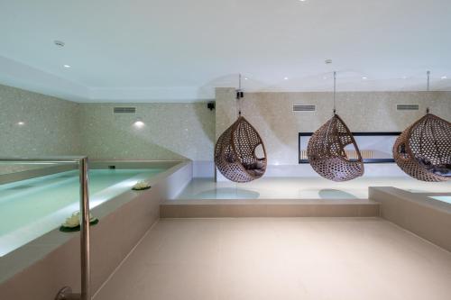 a bathroom with a swimming pool and some lights at Spa & Pool - Studio Apartments 365 in Tirana