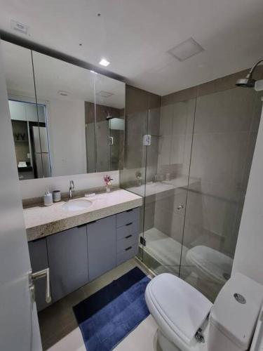 a bathroom with a toilet and a sink and a shower at Flat em Boa Viagem 100% Equipado in Recife
