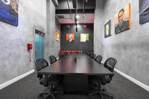 a conference room with a large table and chairs at The O Hotel, Trademark Collection by Wyndham in Los Angeles