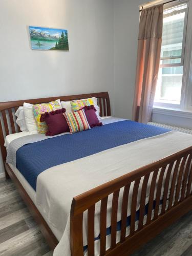 a bedroom with a large bed with pillows and a window at Beach Block Condo in Ventnor City