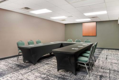 a conference room with a black table and chairs at Best Western Plus Eau Claire Conference Center in Eau Claire