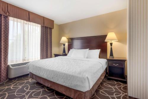 a hotel room with a large bed and a window at Best Western Plus Eau Claire Conference Center in Eau Claire