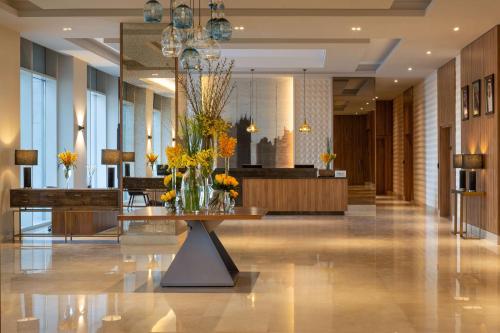a lobby with a table with flowers on it at Hilton Garden Inn Riyadh Financial District in Riyadh