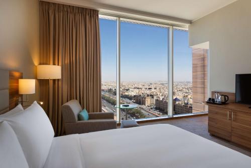 a hotel room with a bed and a large window at Hilton Garden Inn Riyadh Financial District in Riyadh