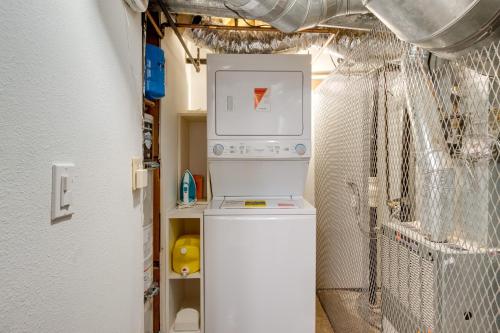 a washer and dryer in a room at 1 Mi to Riverwalk Downtown Reno Studio with Patio! in Reno