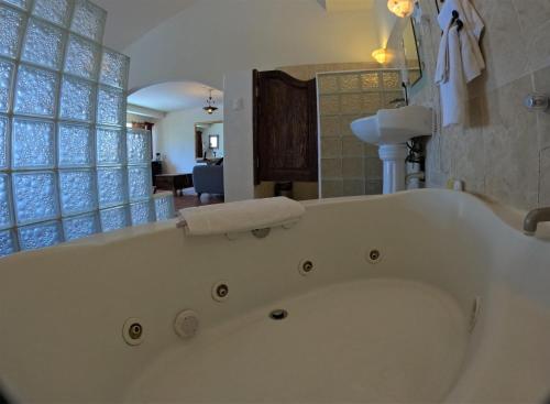 a large white bath tub in a bathroom at La Concha Beach Hotel & Club in La Paz