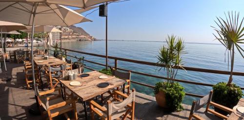 a restaurant with tables and chairs and the ocean at La Concha Beach Hotel & Club in La Paz
