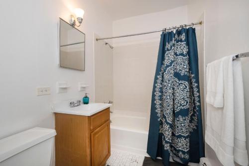a bathroom with a shower curtain and a sink at 1BR in Upper West Side in New York