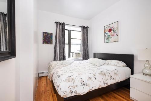 a bedroom with a bed and a window at 1BR in Upper West Side in New York