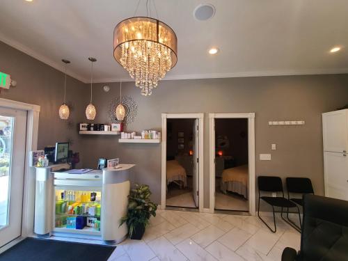 a room with a refrigerator and a chandelier at Twin Peaks Lodge & Hot Springs in Ouray
