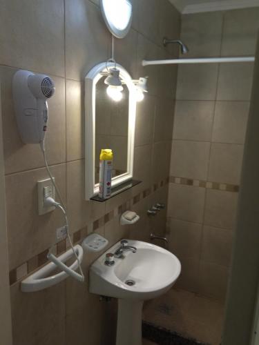 a bathroom with a sink and a mirror at MRU Colón aparts in Colón