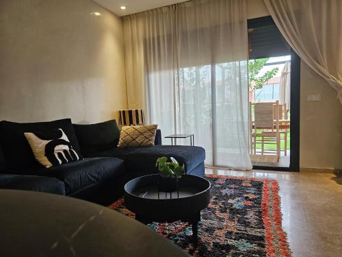 a living room with a couch and a table at LDM Appartements Marrakech in Marrakech