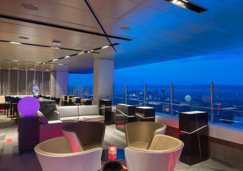 a hotel lobby with a view of the city at Marco Polo Ortigas Manila in Manila