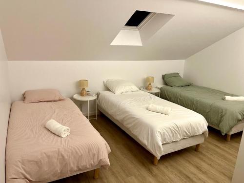 A bed or beds in a room at Cosy House Near Paris, CDG Airport + parking