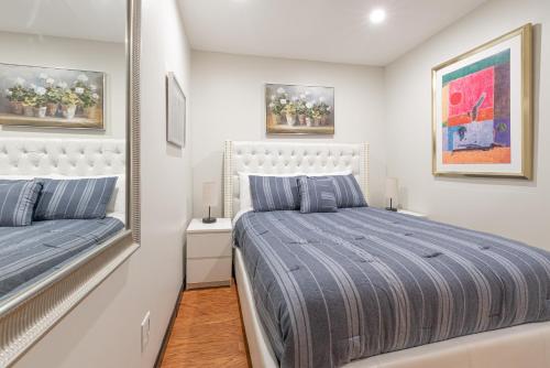 a bedroom with a king sized bed and a mirror at 1BR in Midtown East! in New York