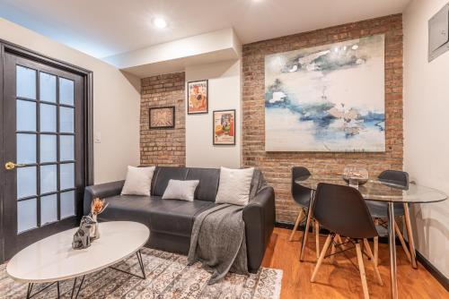 a living room with a couch and a table at 1BR in Midtown East! in New York