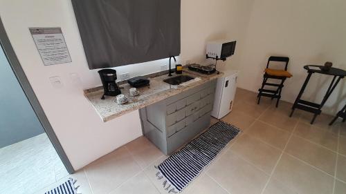 a kitchen with a sink and a counter top at Flat In Paraty in Paraty
