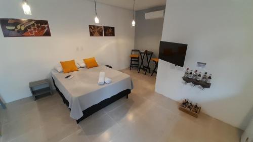 a bedroom with a bed with orange pillows on it at Flat In Paraty in Paraty