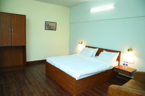 a hotel room with a bed and a couch at Country Inn & Suites By Umrb - Mumbai International Airport in Mumbai