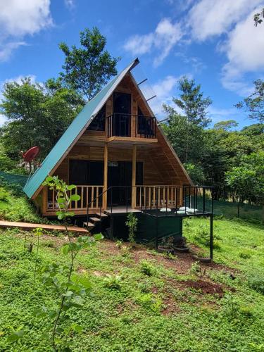 a small cabin with a gambrel roof at Cabañas Los Jobos in Villarreal