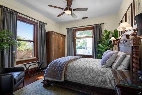 a bedroom with a bed and a ceiling fan at Upscale Downtown Home Walk to Beach shops Bars 2 in Santa Barbara