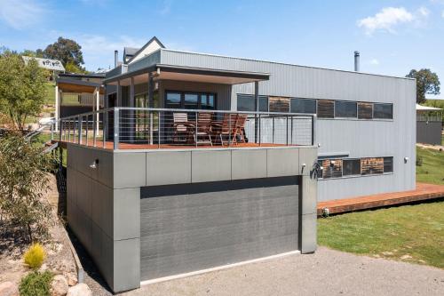 a large house with a balcony on top of it at Black Diamond - Luxury Alpine Home in Merrijig - Sleeps 14 in Merrijig