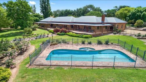 an aerial view of a house with a swimming pool at Cornhill - Merrijig - Sleeps 12 in Merrijig