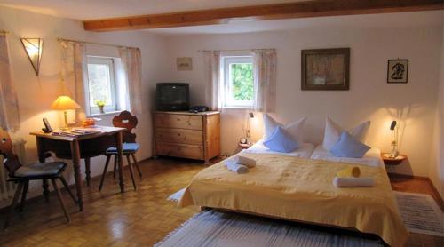 a bedroom with a bed and a table and a desk at Landgasthaus Schwarzbachtal in Lohsdorf