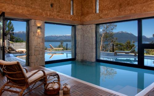 a house with a swimming pool with views of the mountains at Luma Casa De Montaña in Villa La Angostura