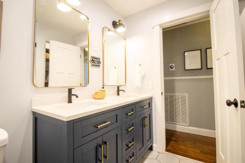 a bathroom with a sink and a mirror at Paris Mtn Wedding Home - Family Friendly in Greenville