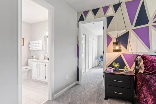 a bathroom with a purple and purple geometric wall at The Safari House: Where Adventure & Comfort Awaits in Richmond