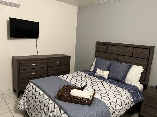 a bedroom with a bed with a basket on it at Blu Lime Apartments in San Juan