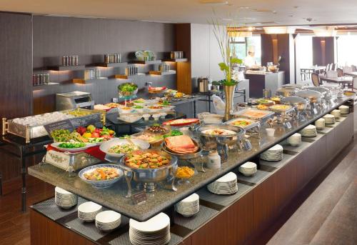 a buffet line with many different dishes of food at Toba International Hotel in Toba