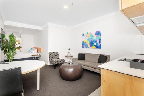 a living room with a couch and a table at Downtown Perth Studio On Murray Street in Perth
