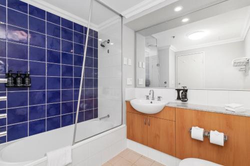 a bathroom with a toilet and a sink and a shower at Downtown Perth Studio On Murray Street in Perth