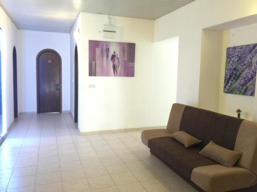 a living room with a couch in a room at Pansion Ruža in Novi Vinodolski
