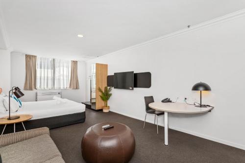 a hotel room with a bed and a table at Perth Cbd Oasis Murray Street Studio in Perth