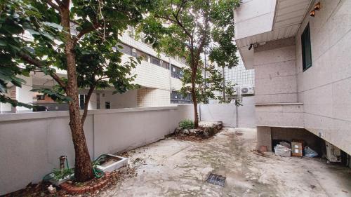 a courtyard with trees in front of a building at Haechi Stay GuestHouse - For foreigners only in Seoul