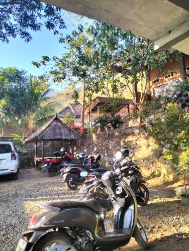 a group of motorcycles parked next to a building at Fullmoon homestay in Kuta Lombok