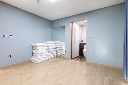 a room with a stack of towels on a wall at The Bay Jeju Resort in Seogwipo
