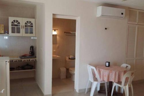 a kitchen and dining room with a table and chairs at Marysol private beach next to nomads d5 in Isla Mujeres