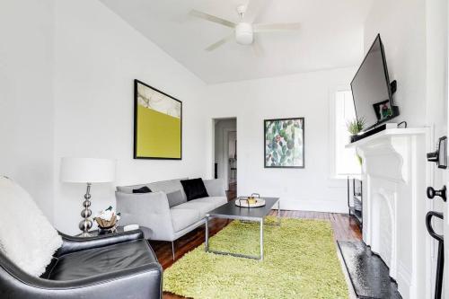 a white living room with a couch and a table at Chic Urban Couples Retreat: Perfect Getaway 'n RVA in Richmond
