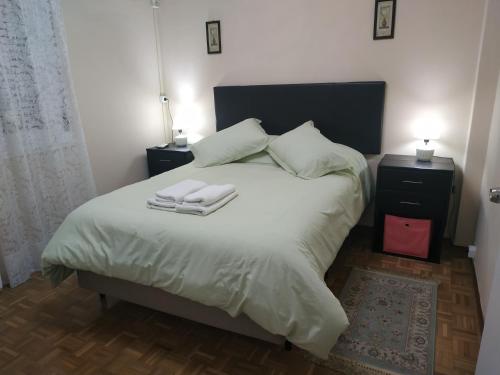 een slaapkamer met een bed met twee handdoeken erop bij Hermoso Apto de 3 Dormitorios 86m2 en Tres Cruces in Montevideo