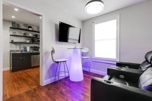 a living room with a couch and a tv at Charming, Happy 1-Bed Oasis: RVA Retreat Awaits! in Richmond