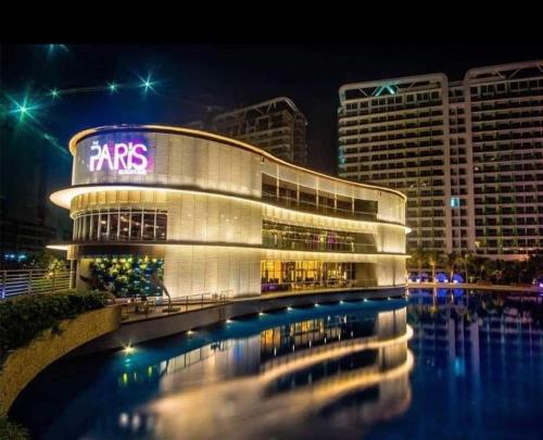 a large building with a sign on it at night at Velvet Waves in Manila